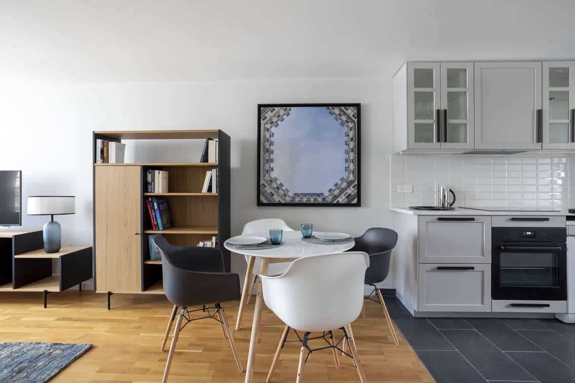 Close-up of the dining area with its shell armchairs and a photo of the Haussmannian courtyardby Christiansen Design, Interior designer in Yvelines and Decorator in Paris, Hauts de Seine, Provence